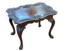 Mahogany shaped top low table having carved eagle head and floral border on cabriole legs,