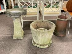 Octagonal weathered bird bath on tapering pedestal,