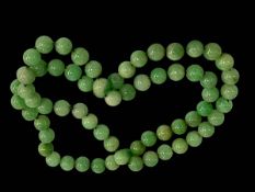 Green jade bead necklace, 76cm.