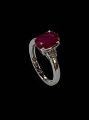 18 carat white gold, Burmese ruby and diamond three stone ring, the oval ruby 3.