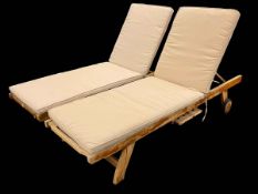 Pair Lindsey Plantation teak portable adjustable reclining sun loungers with slide out trays,