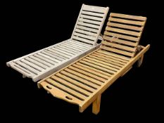 Two teak portable adjustable reclining sun loungers with slide out trays, 200cm by 61cm.