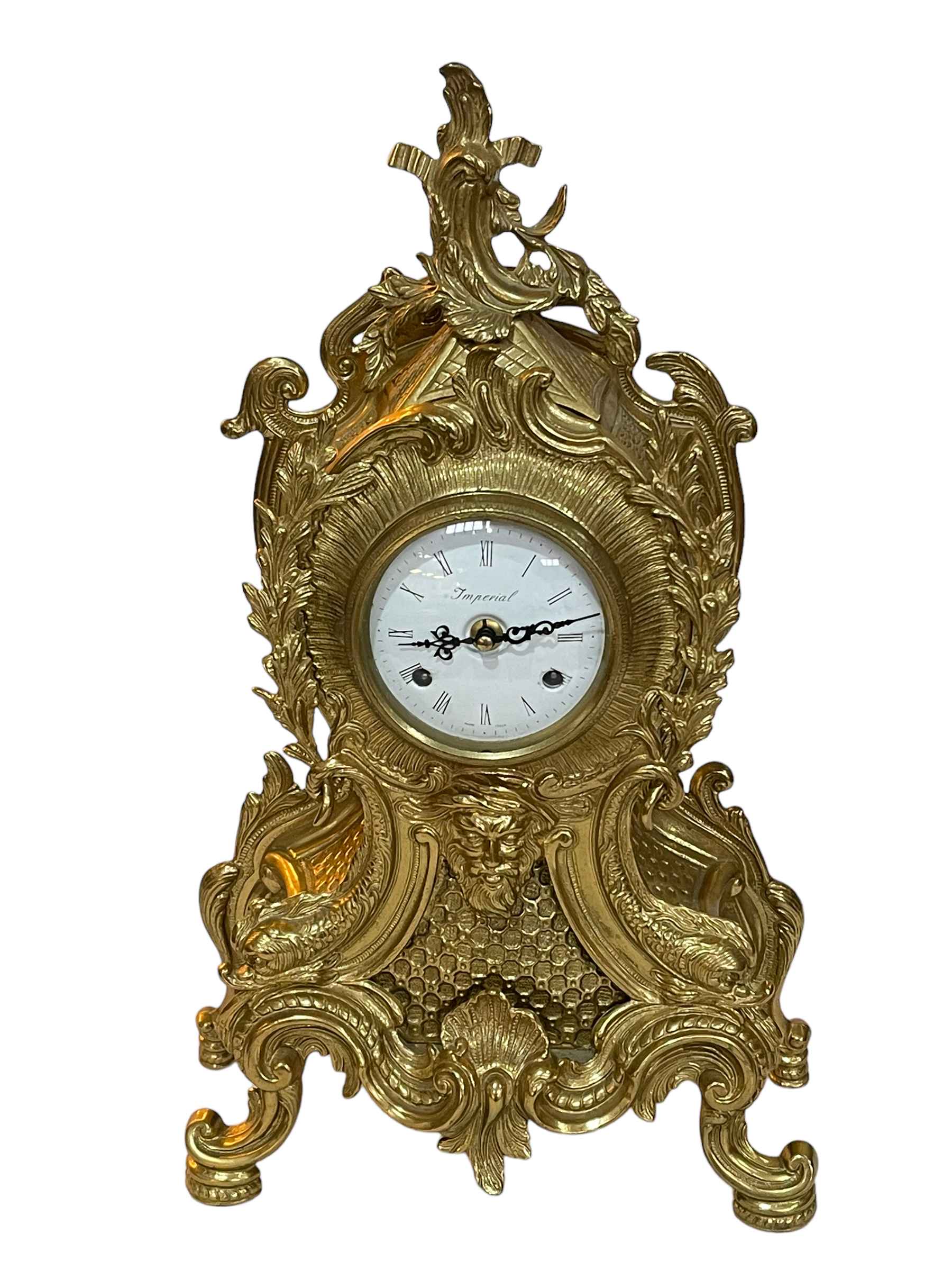 Ornate brass mantel clock with white dial, 48cm.
