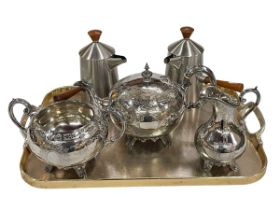 Three piece silver plated tea service and pair of stainless steel chocolate pots.