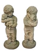 Pair of weathered garden figures of children with puppy and kitten.