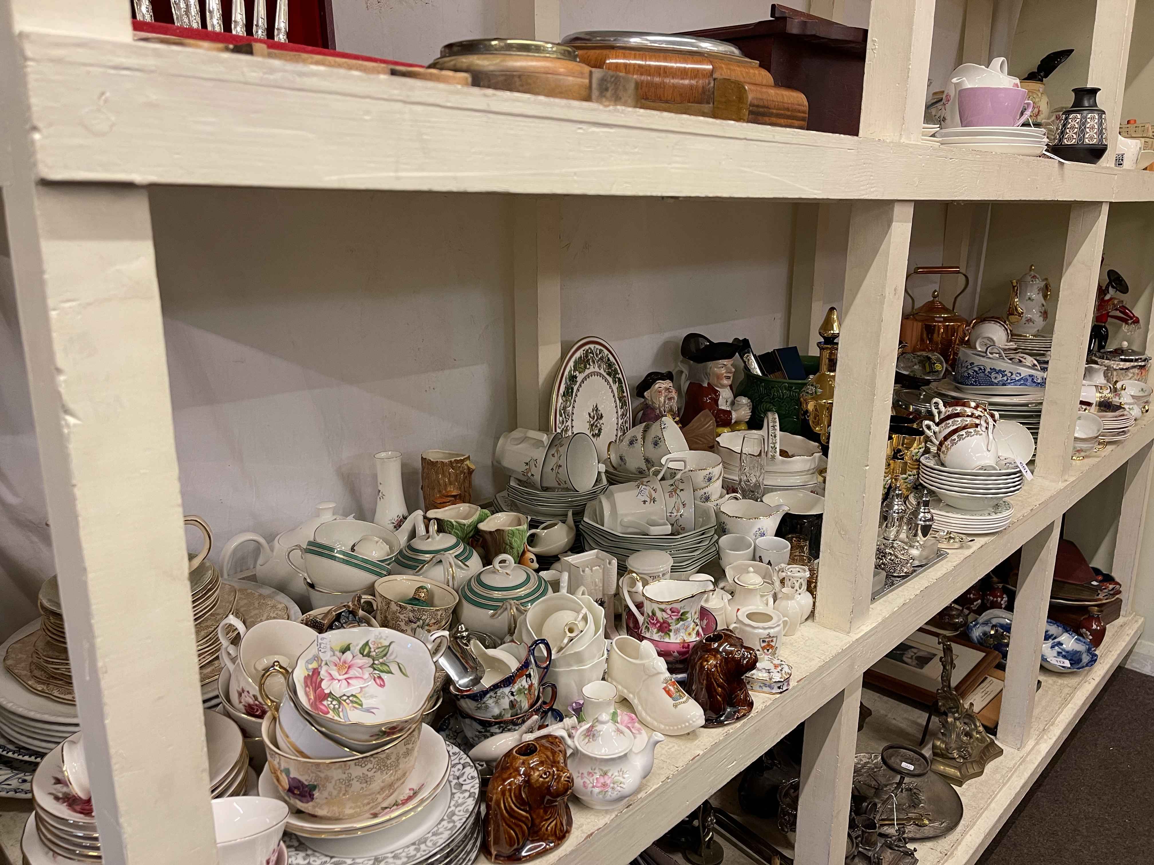 Full shelf of china tea and dinnerware, two toby jugs, glass, metalwares, barometers, wall clock,