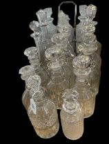 Seventeen 19th Century and later cut glass decanters, together with a three bottle decanter stand.