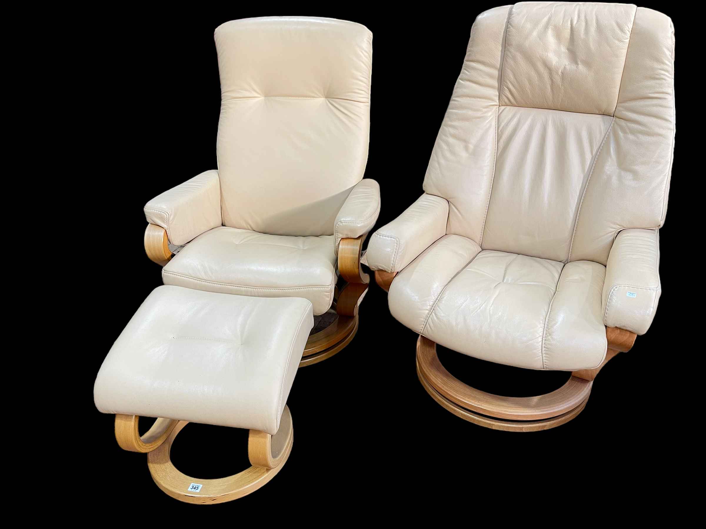 Two similar Himolla leather swivel reclining chairs and one footstool.