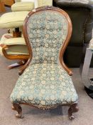 Victorian mahogany framed spoon back nursing chair in green buttoned tapestry fabric.