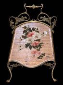 Edwardian brass and floral painted mirror firescreen, 81cm by 56cm.