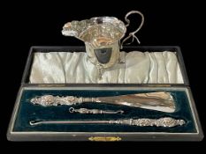Boxed silver shoehorn, button and glove hooks set, Birmingham 1901 and cream jug, Chester 1918.