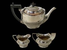 Silver matched three piece part fluted tea set, Birmingham 1904 and 1922.