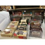 Collection of Corgi model buses and two model vehicle display cases.