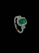 Emerald and diamond 18 carat white gold cluster ring, the rectangular emerald 1.