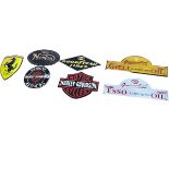 Seven cast metal motoring signs including Harley Davidson, Norton, Esso, etc.