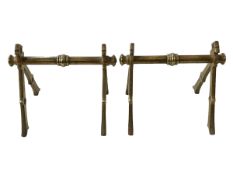 Pair brass fire iron rests in Dresser style.