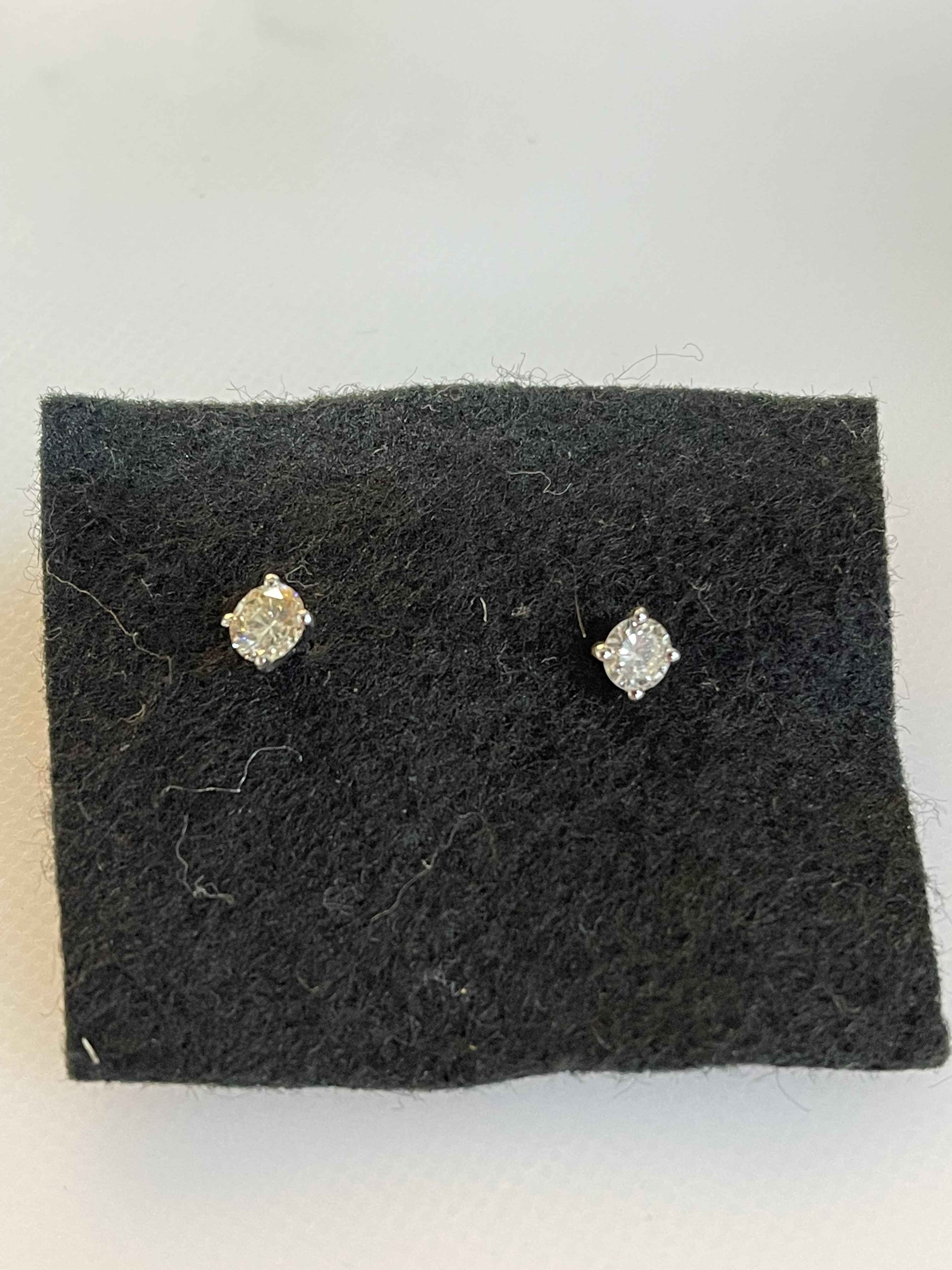 Pair of 18 carat white gold and diamond stud earrings, diamonds 0.51 carats.