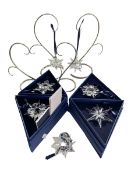 Seven Swarovski annual Christmas Stars 2002, 03, 05, 06, 07, 08 and 09 and four display stands.