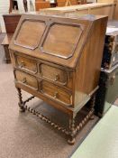 Jacobean style oak two drawer bureau on barley twist legs, 105cm by 75.5cm by 45cm.