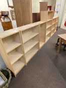 Set of six beech finish open bookcases, largest 140cm by 80cm by 28cm.