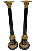 Pair of ornate Regency style brass and black column candlesticks, 55cm.