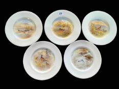 Set of five Royal Doulton hand painted plates four decorated with birds in landscape and one with