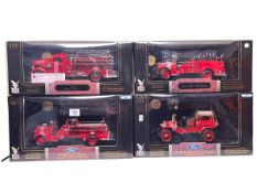 Four Road Signature Models of American Fire Trucks each with 24k gold plated coin, boxed as new.