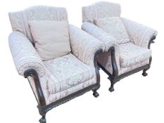 Pair early 20th Century carved mahogany framed armchairs on ball and claw legs in classical fabric.