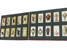 Wills cigarette card album and assorted cigarette cards.