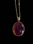 Large oval ruby pendant set in 18 carat yellow gold mount on chain.