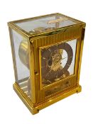 Jaeger Le Coultre gilt brass Tuxedo Atmos clock, with fluted front door, 22.5cm high, 13.5cm depth.