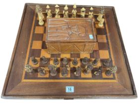 Ghanaian carved chess set with box and chess board.