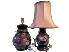 Two Moorcroft Pottery table lamps of bulbous form decorated with anemone on blue ground.