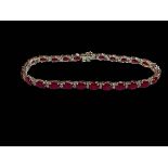 18 carat white gold, ruby and diamond bracelet, the oval rubies totalling 12.20 carats, diamond 0.