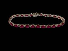 18 carat white gold, ruby and diamond bracelet, the oval rubies totalling 12.20 carats, diamond 0.