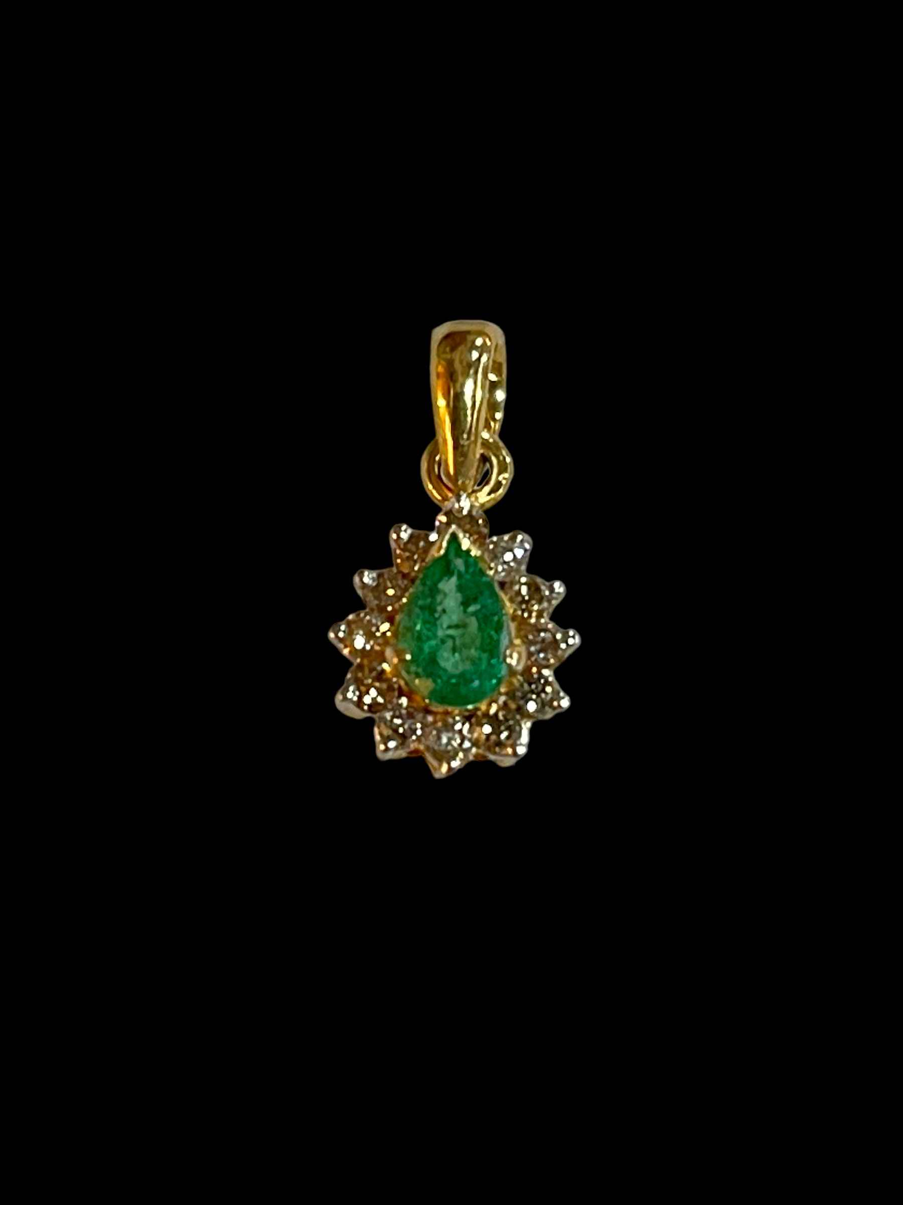 Emerald and diamond cluster pendant set in 18 carat yellow gold.