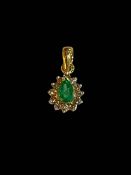 Emerald and diamond cluster pendant set in 18 carat yellow gold.