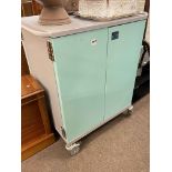 Four door fitted portable medical? cabinet, 102.5cm by 91cm by 62cm.