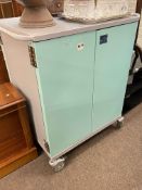 Four door fitted portable medical? cabinet, 102.5cm by 91cm by 62cm.