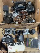 Collection of cameras and accessories including Canon T90, Minolta SR101, various lenses, etc.