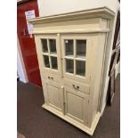 Painted scullery cabinet having two glazed panel doors above two drawers with two cupboard doors