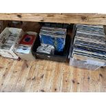 Four boxes of LP and single records including Bruce Springsteen, Queen, etc.