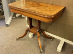 Victorian mahogany crossbanded fold top tea table raised on twin pillars to splayed legs,