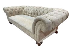 Chesterfield settee in deep buttoned light gold fabric.