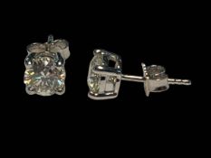 Pair of diamond stud earrings set in 18 carat white gold,
