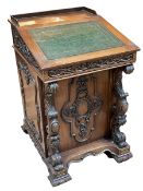 Carved rosewood? Davenport with sliding ledger and carved panel door enclosing six drawers,