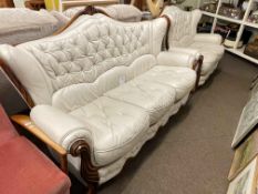 Pair ivory buttoned leather and polished frame three seater and two seater settees.