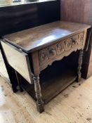 Carved oak drop leaf side table having frieze drawer raised on turned legs joined by undershelf,