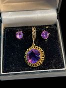 Amethyst pendant and 15 carat gold chain and 9 carat gold amethyst earrings.