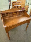 Pine two drawer writing table having upper open compartments and two small drawers,